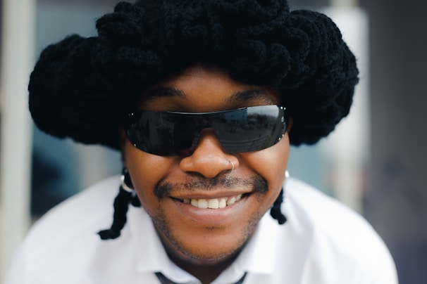 A customer smiling confidently with a bold, curly wig styled for a night out.