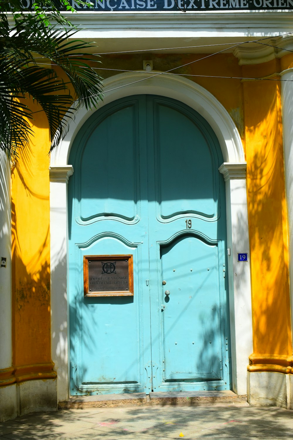 a blue and yellow building with a blue door