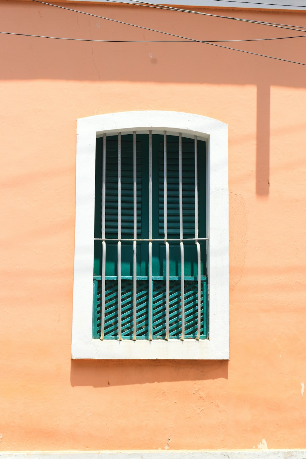 a window with bars on the side of a building