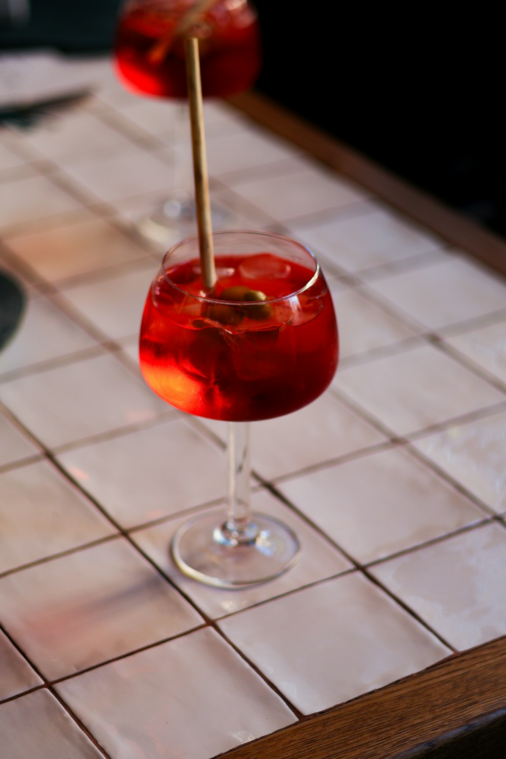 a close up of a wine glass on a table