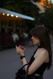 A happy young woman checking her smartwatch while jogging in a sunny park