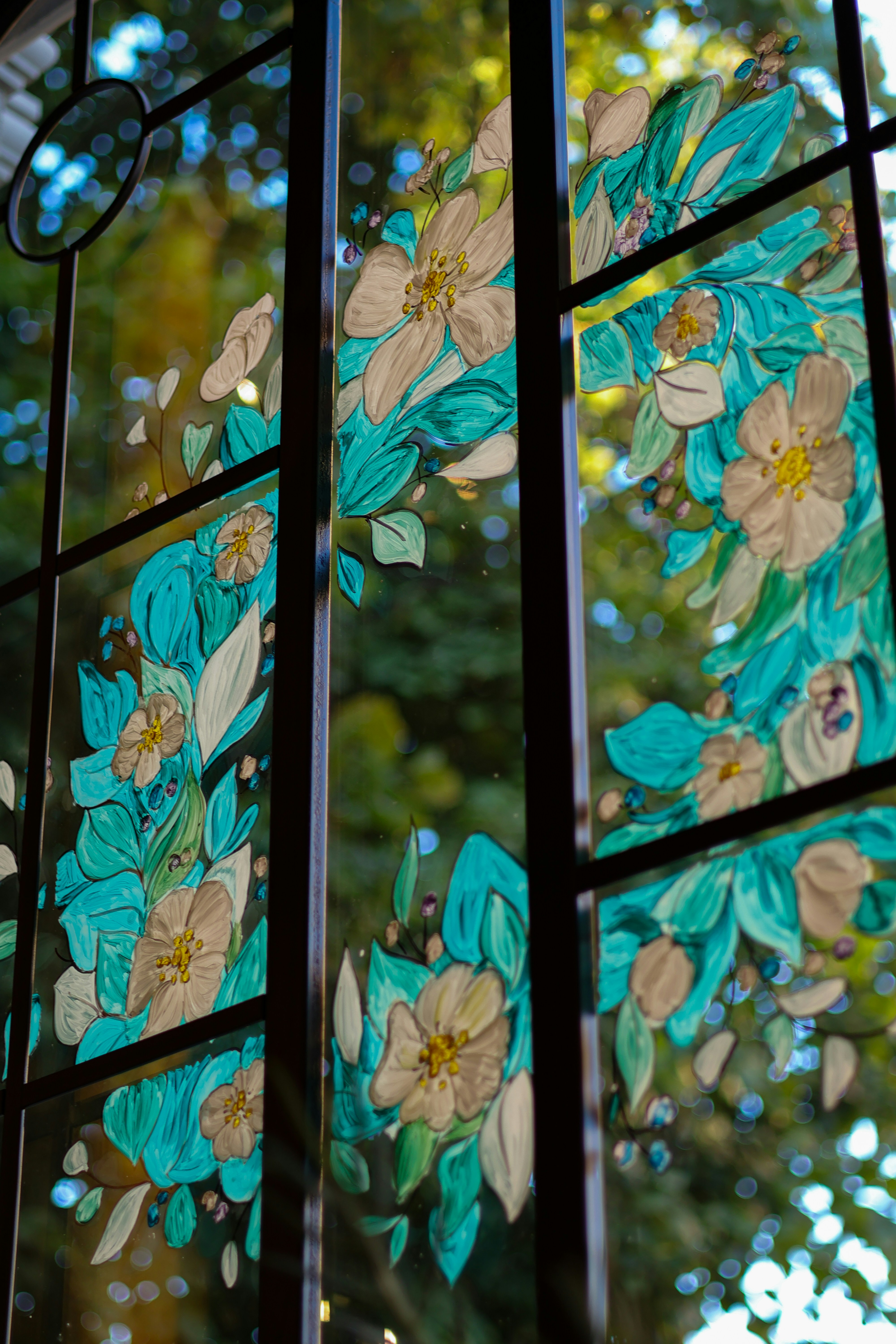 a close up of a stained glass window with flowers