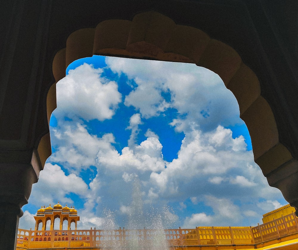 a view of a fountain from under a building