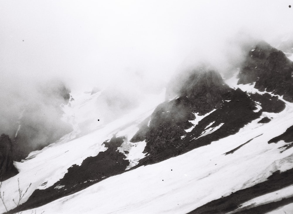 a black and white photo of a snow covered mountain