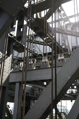 Steel anchoring system setup with golden-hued beams under dramatic lighting.