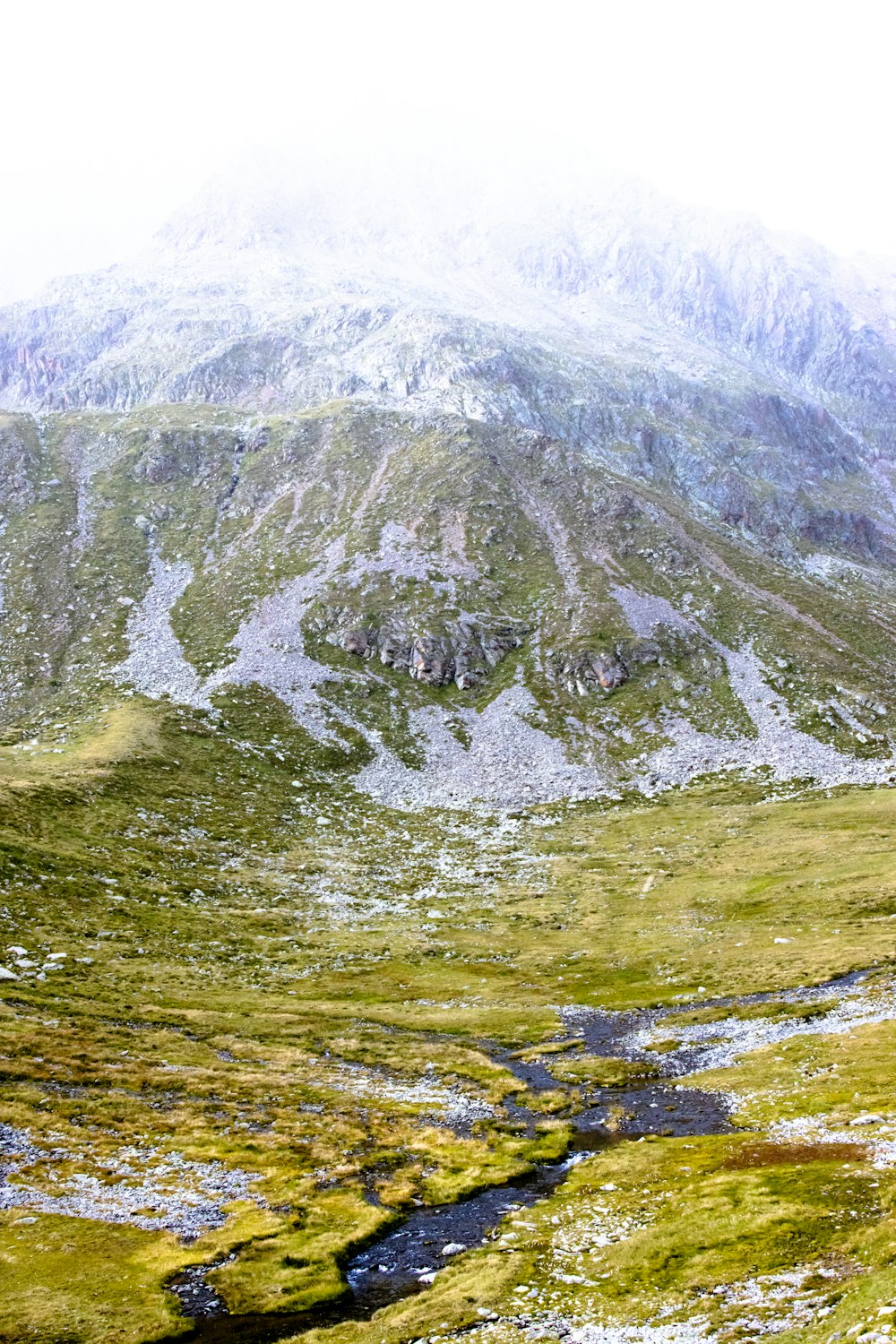 a mountain with a stream running through it