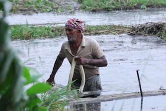 A technician inspecting a flooded area with equipment.