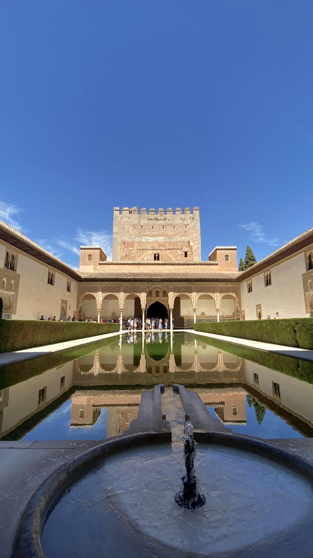 a large building with a fountain in front of it