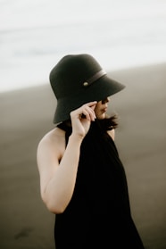 Close-up of a model wearing a sleek sunfit apparel UV-protective hat with a wide brim.