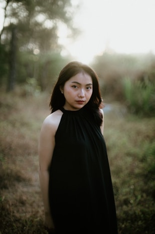 A serene editorial photo of a model wearing eco-friendly clothing in a natural setting.