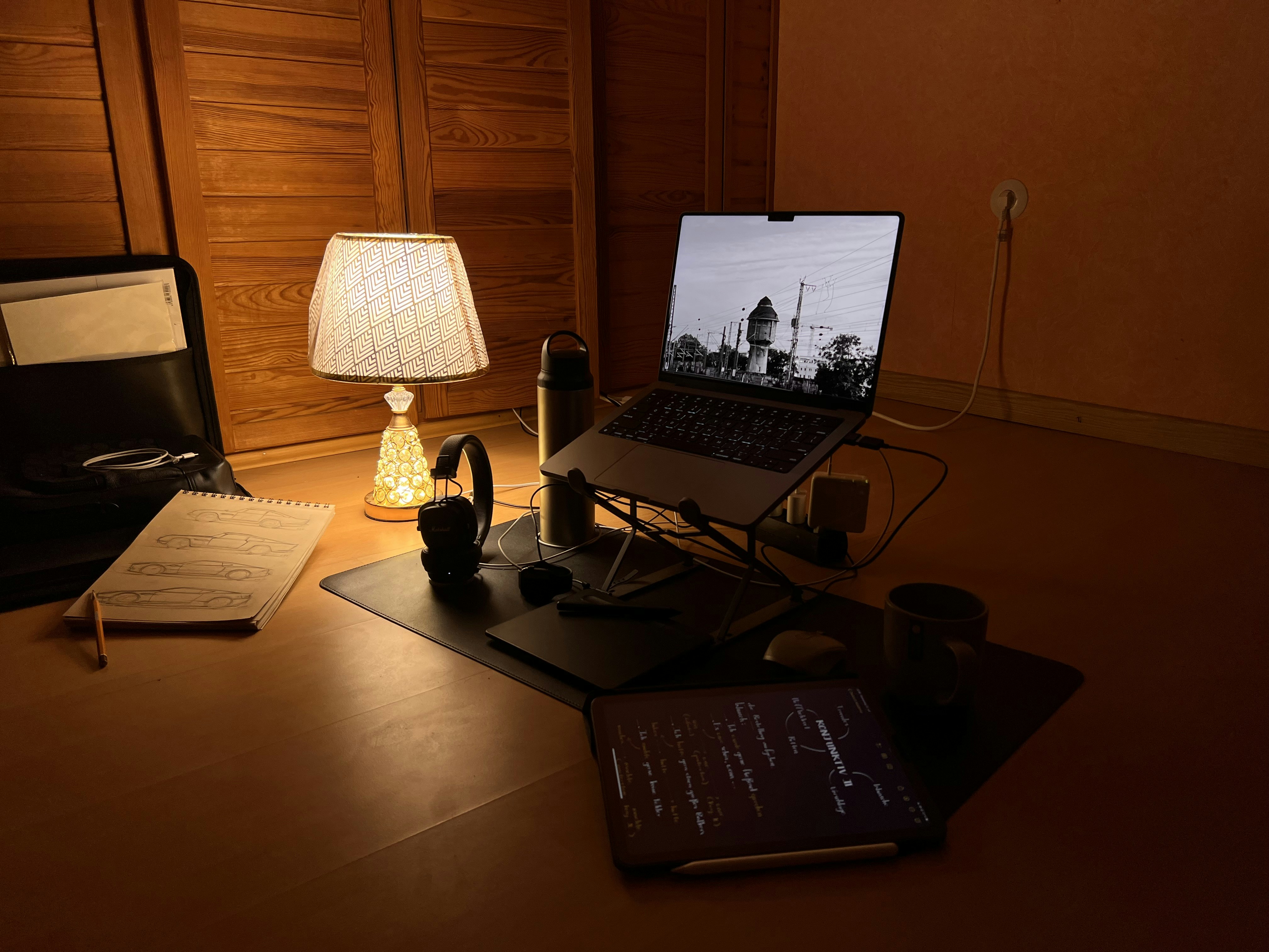Cozy desk setup with warm lamp light and open notebook, perfect for focused study