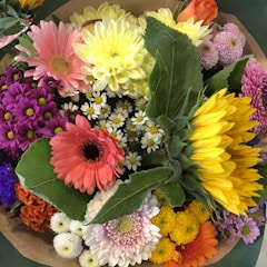 A colorful summer bouquet with sunflowers and daisies.