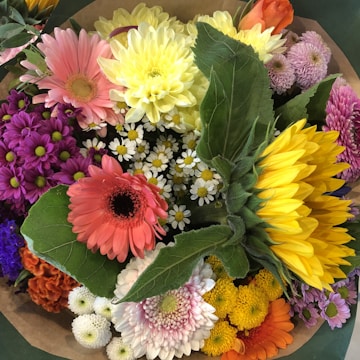A colorful summer bouquet with sunflowers and daisies.