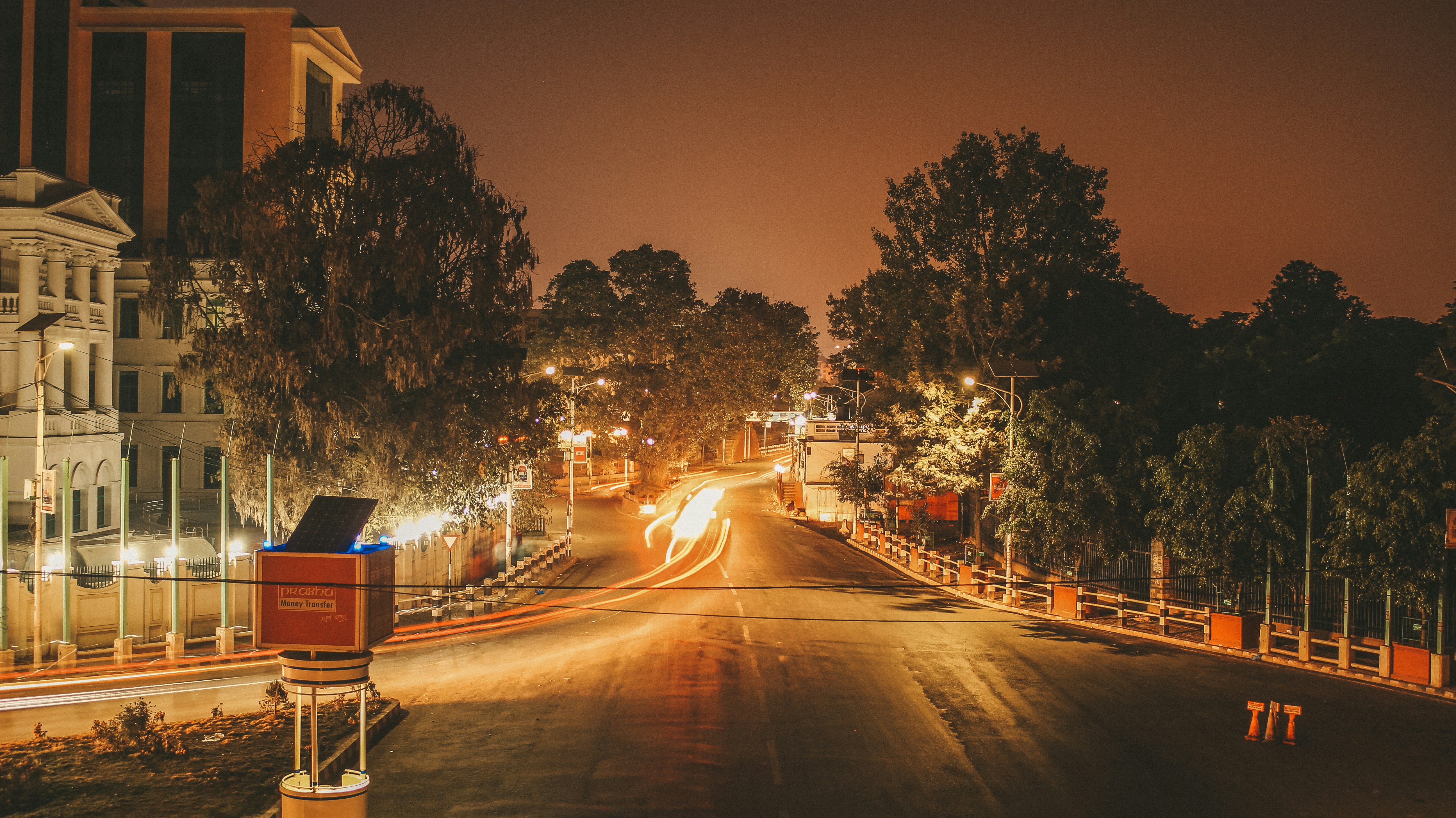 a city street at night with traffic lights