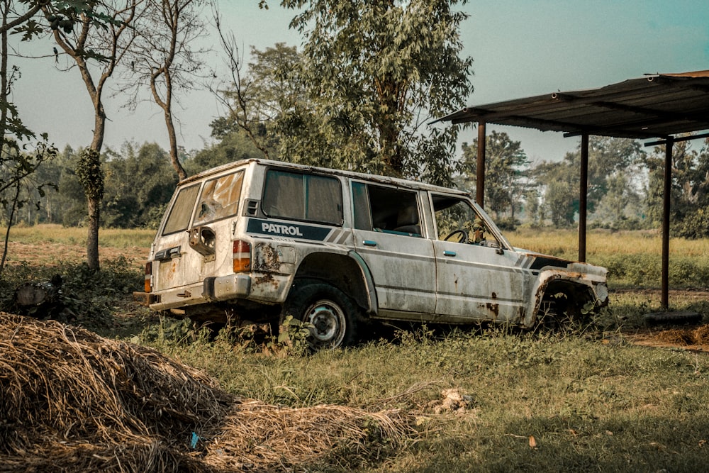 a rusted off jeep parked in a field