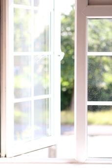 A bright, newly installed vinyl window in a cozy Ontario home letting in natural light.