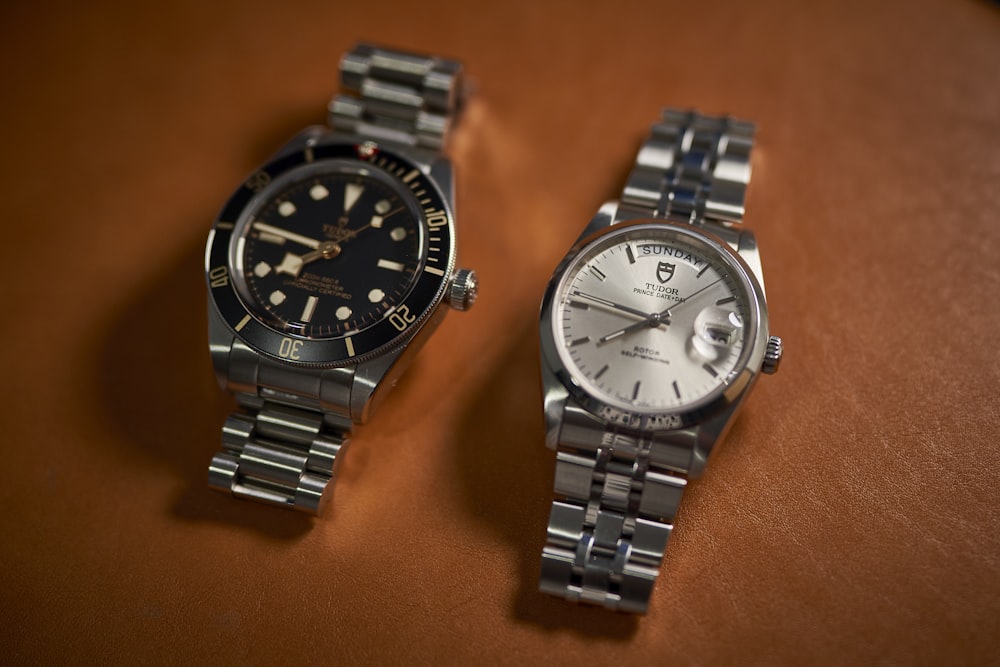 a couple of watches sitting on top of a table