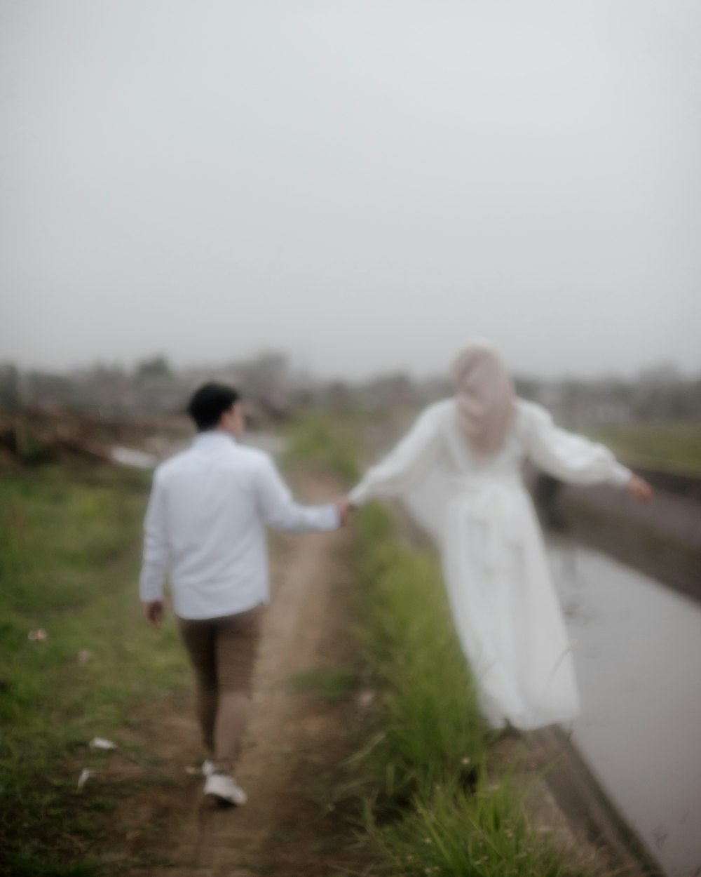 a blurry photo of a couple walking down a path