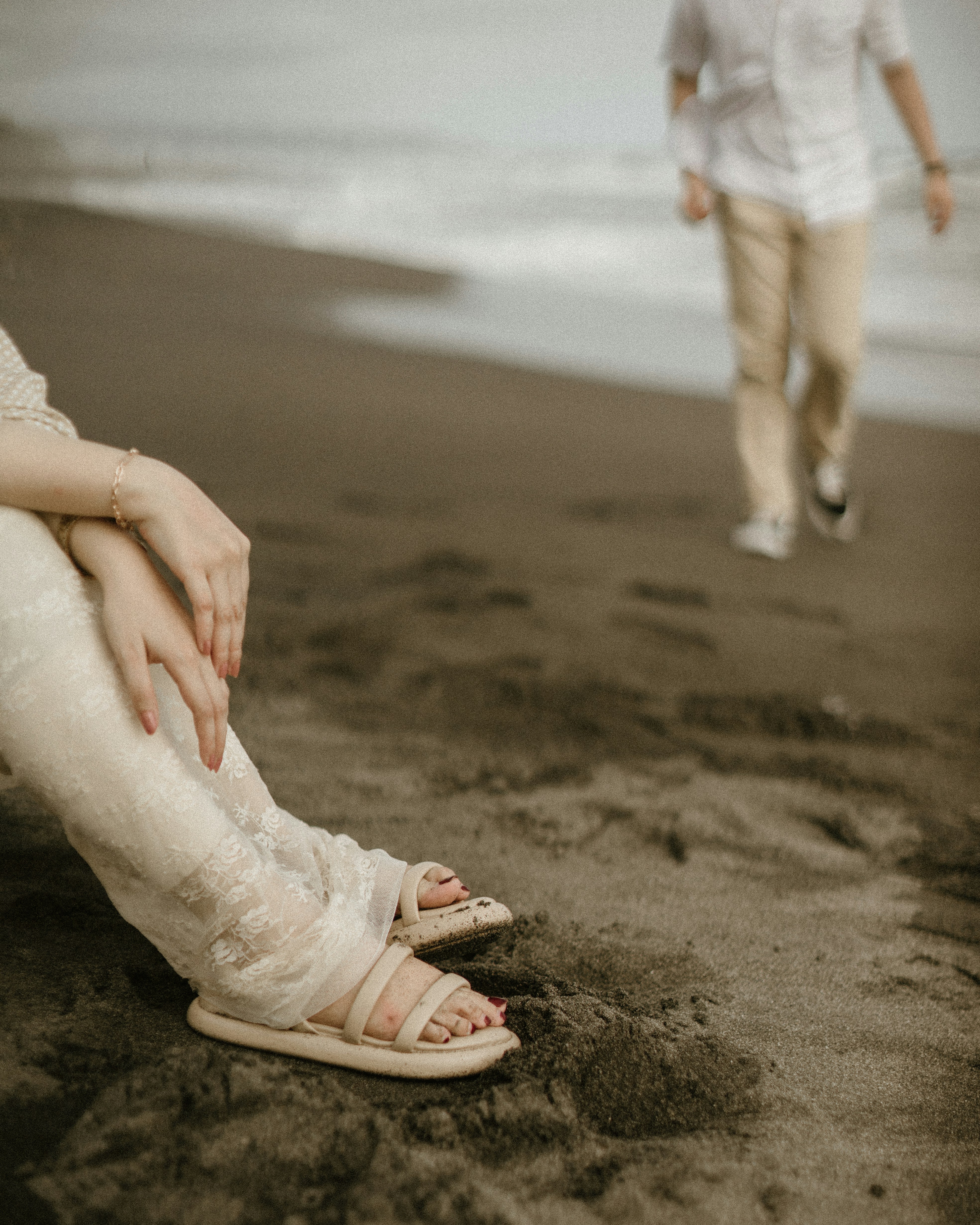 a couple of people that are sitting in the sand