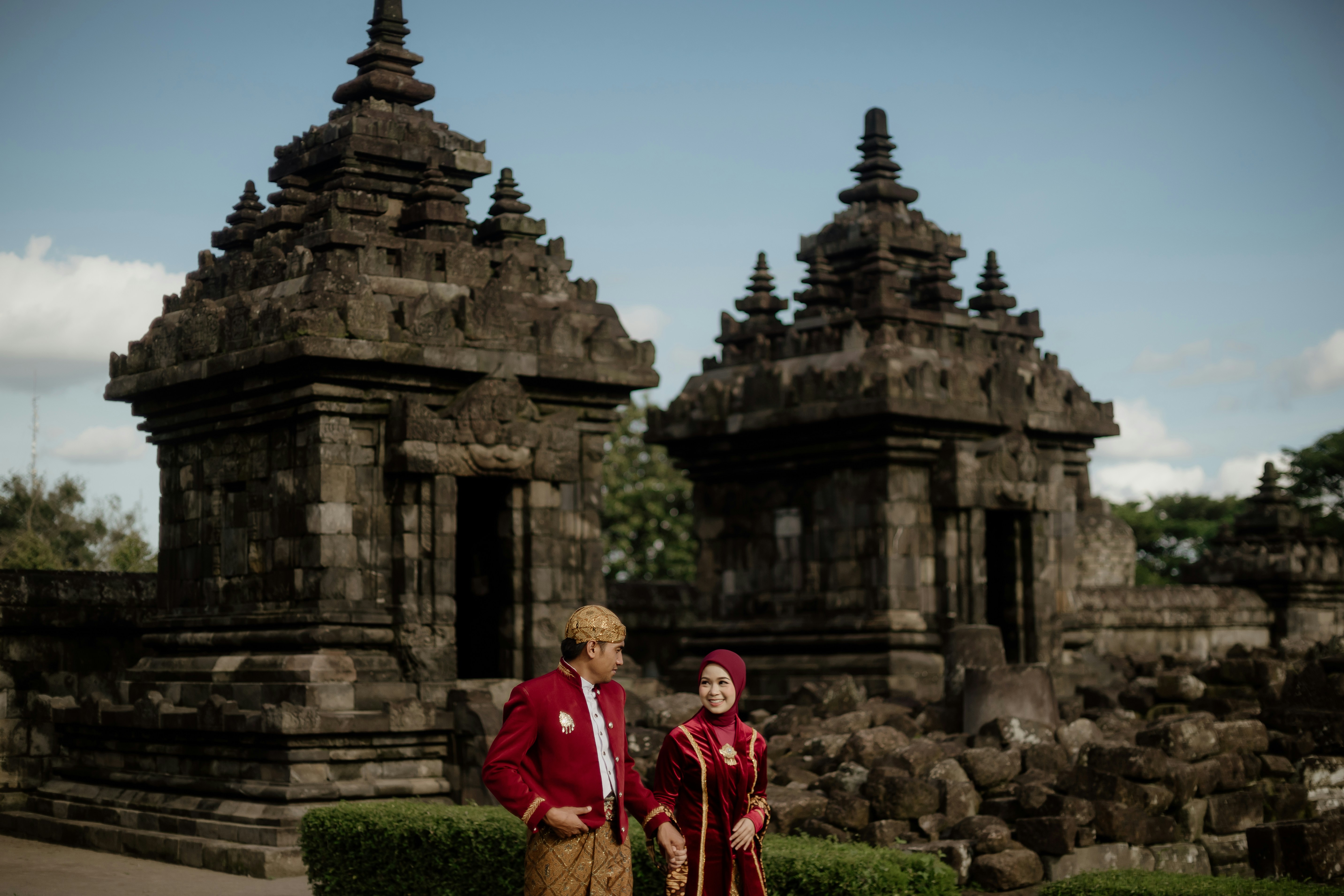 a man and a woman standing in front of a building