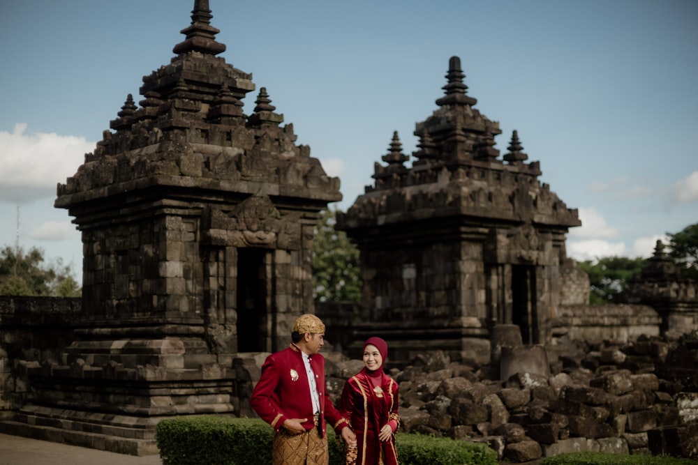 a man and a woman standing in front of a building