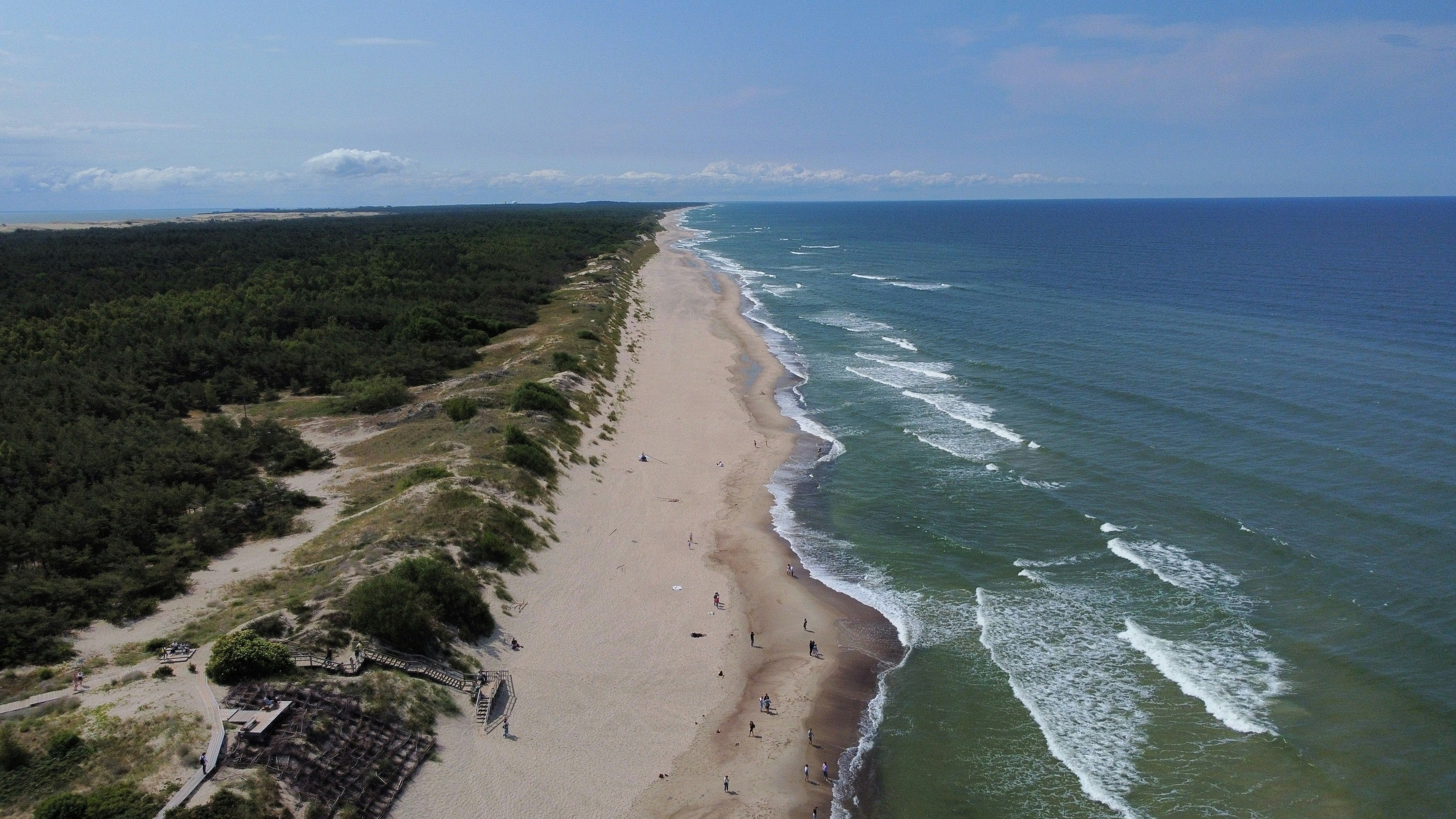 an aerial view of a sandy beach and ocean