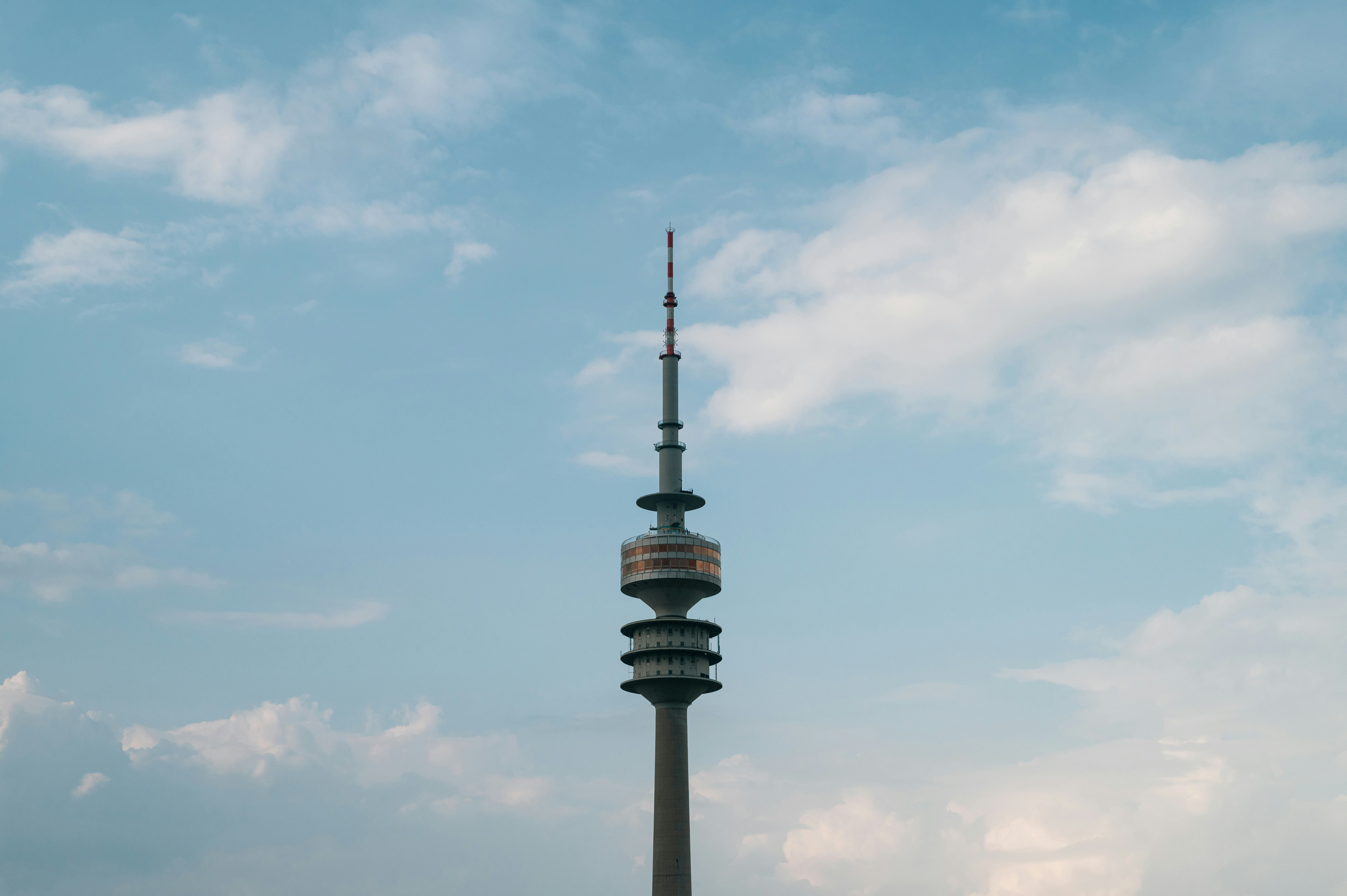 a tall tower with a sky background, An olympic tower (Olympiaturm) located in the Olympic Park (Olympiapark) in Germany, Munich.