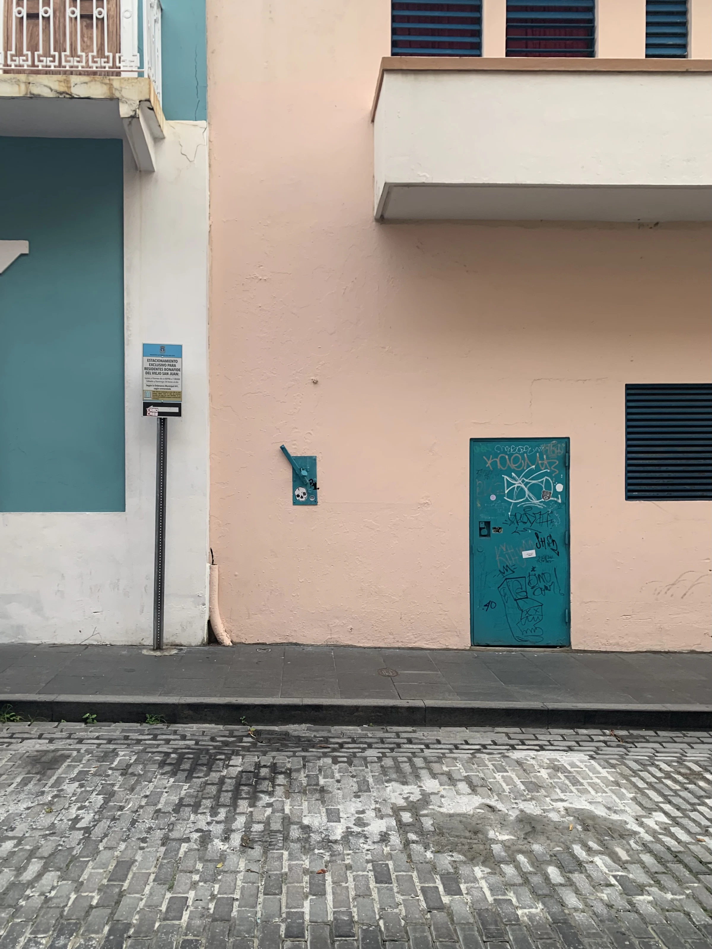 A pink building with blue shutters in Puerto Rico