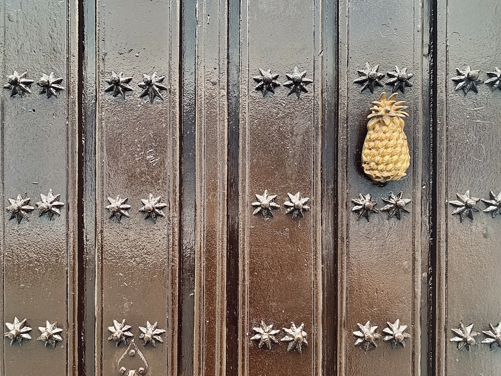 a metal door with a pineapple on it
