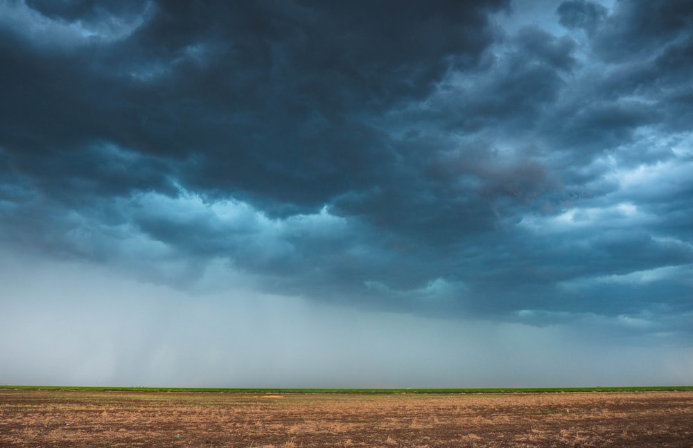 a large open field under a cloudy sky