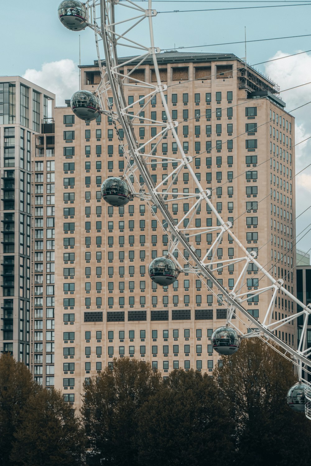 a ferris wheel in front of a tall building