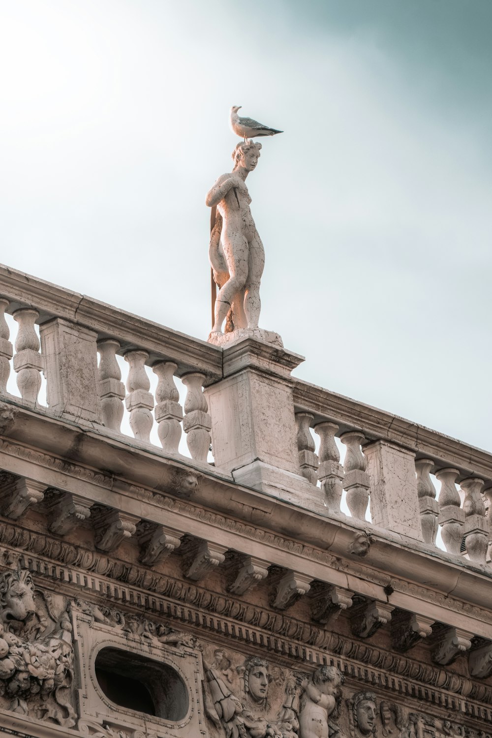 a statue of a bird on top of a building