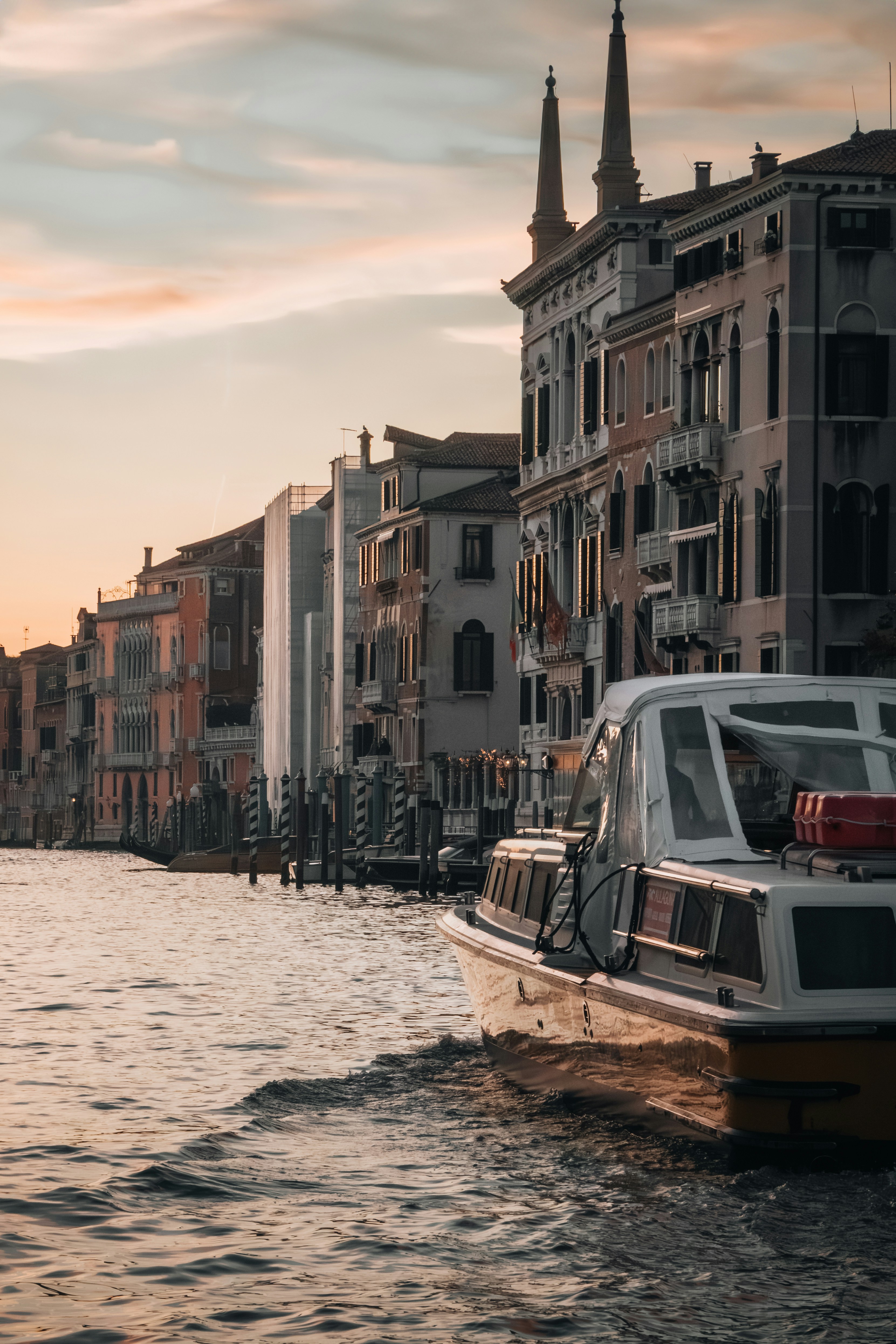 A boat traveling down a river next to tall buildings photo – Free ...