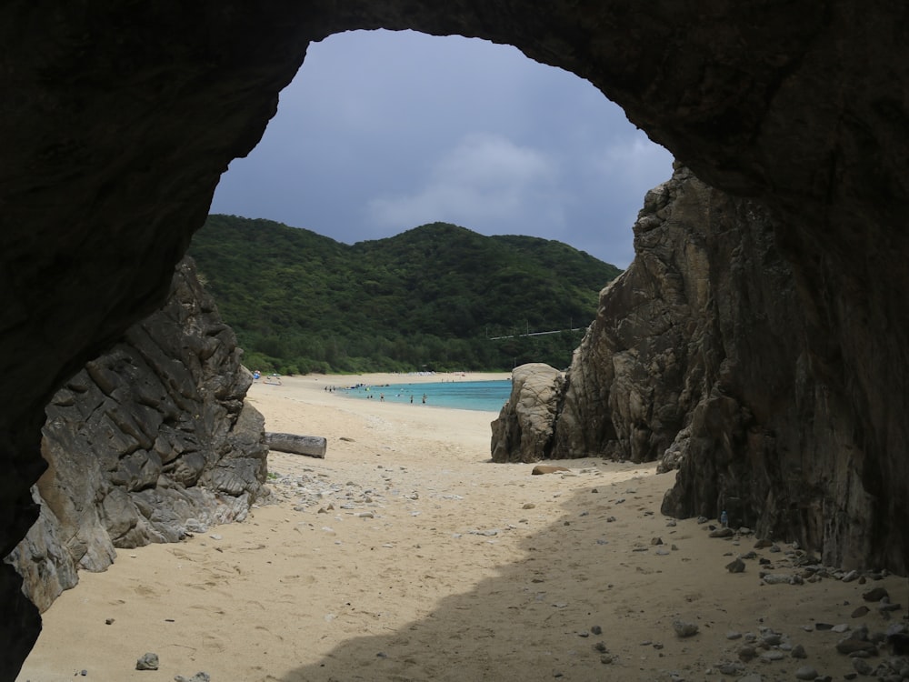 a view of a beach through a cave