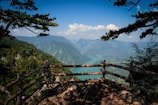 A scenic mountain viewpoint overlooking a winding river and lush green valleys.