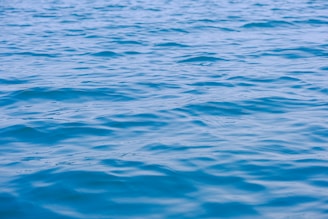 A calm water surface reflecting a clear sky, symbolizing clarity and trust in consulting.