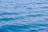 Calm and expansive water surface with gentle ripples reflecting the blue of the sky.