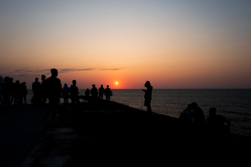 A joyful group of travelers sharing a sunset moment on a quiet Argentine beach.