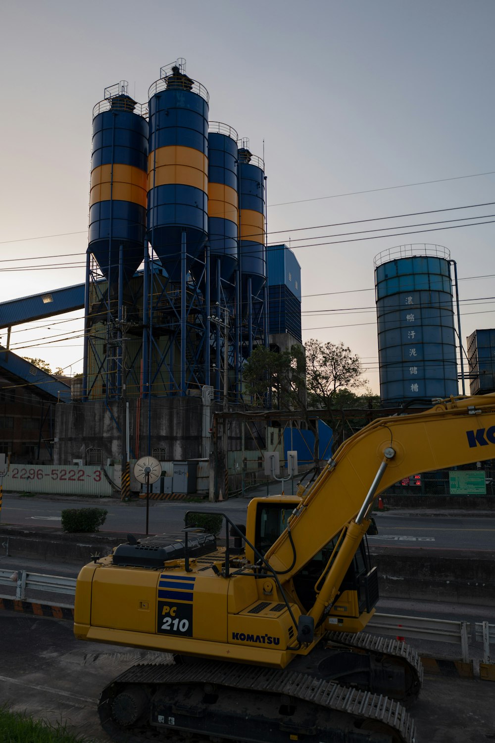 a yellow bulldozer parked in front of a factory