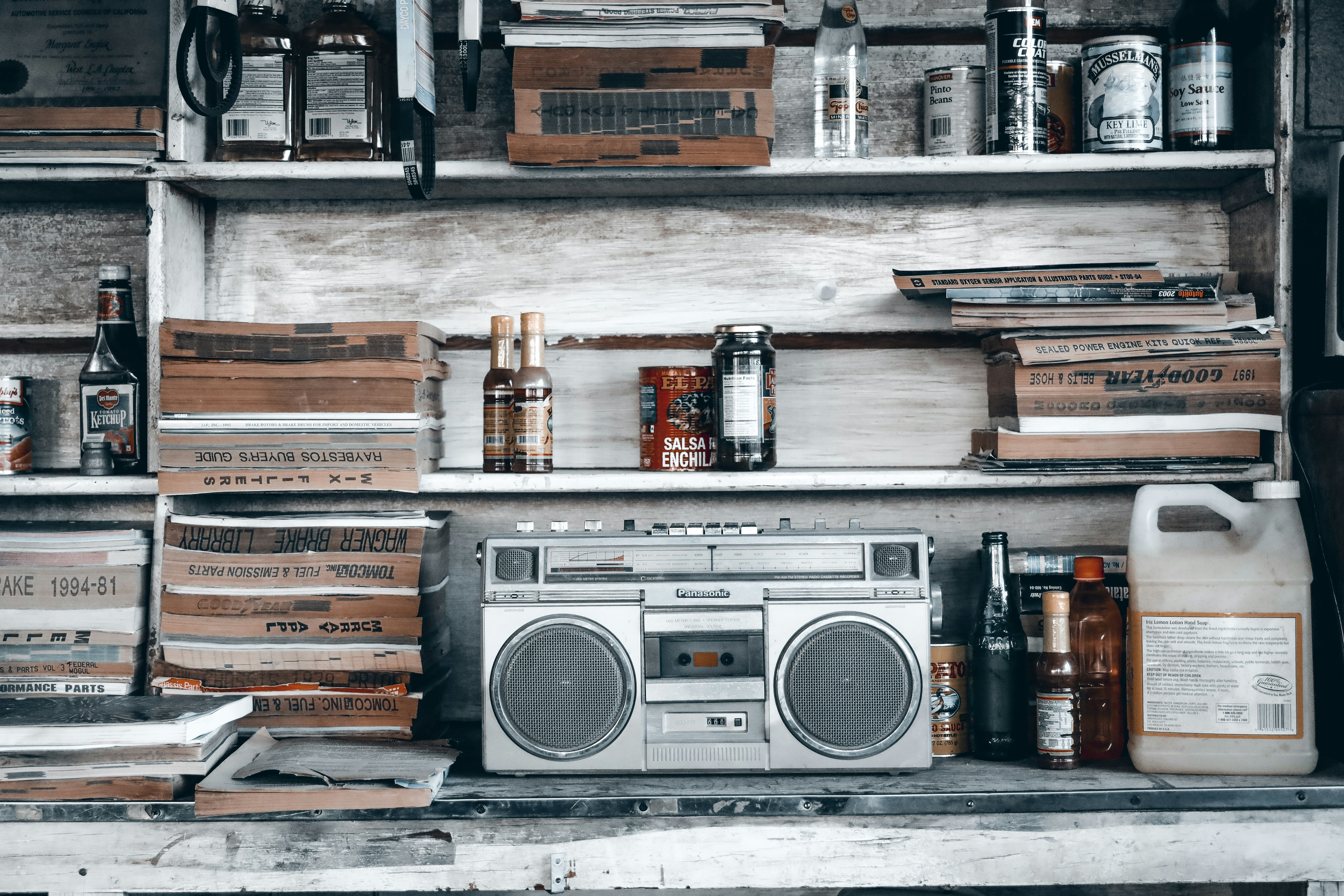 a shelf filled with lots of books and a radio