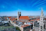 A panoramic view of a historic city skyline with church spires and rooftops under a clear blue sky.