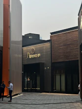 Architect speaking with a client over project plans in a bright, modern office in Guaynabo.