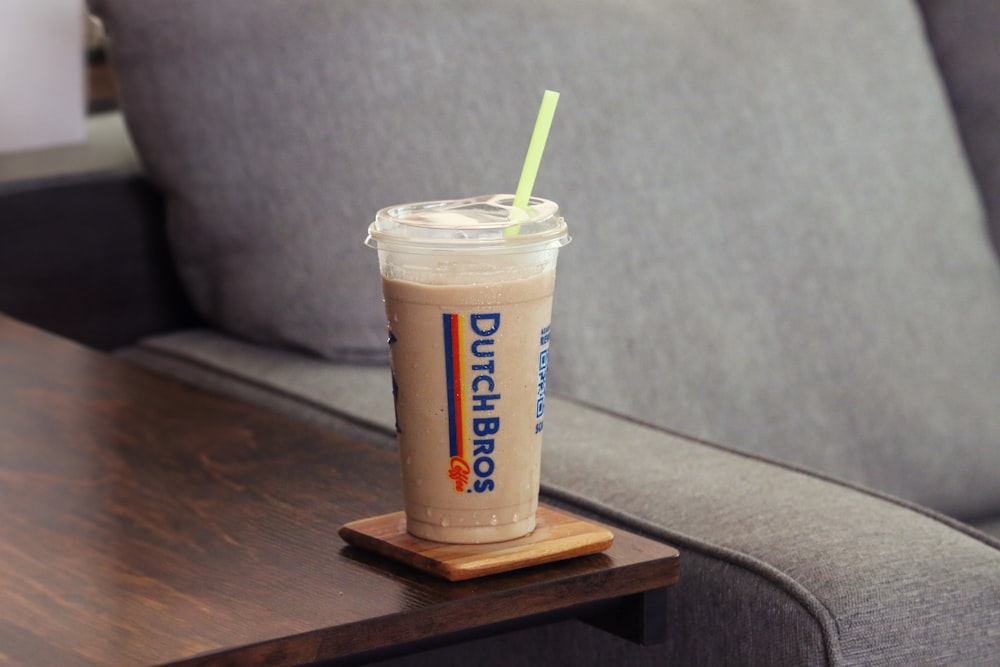 a drink sitting on top of a wooden table