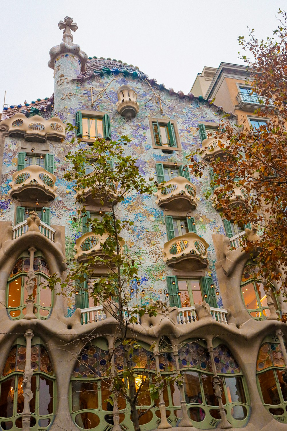 a tall building with many windows and a clock on the top of it