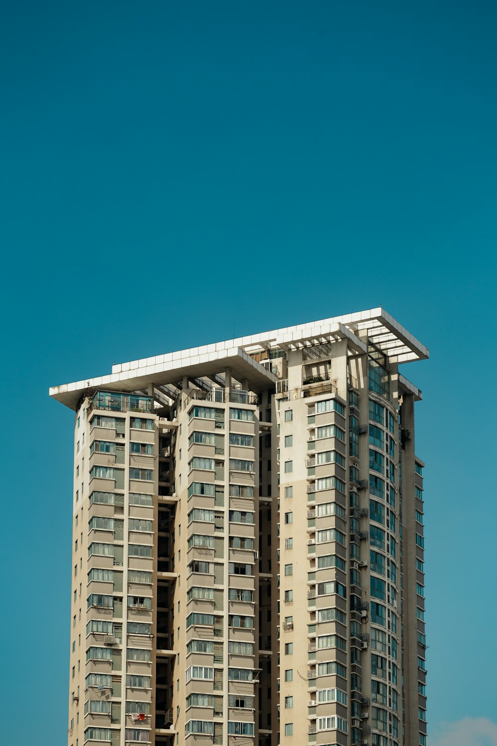 a tall building with balconies on top of it