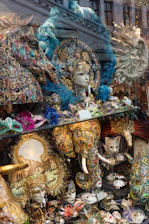 A vibrant display of ornate African masks and decorative feathers arranged artistically.