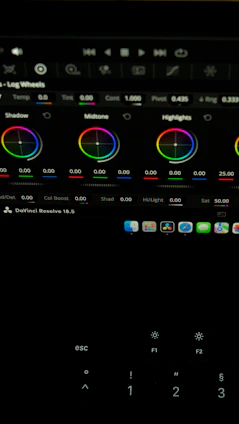 Close-up of a color grading workspace with DaVinci Resolve interface on screen, showcasing vibrant color wheels.