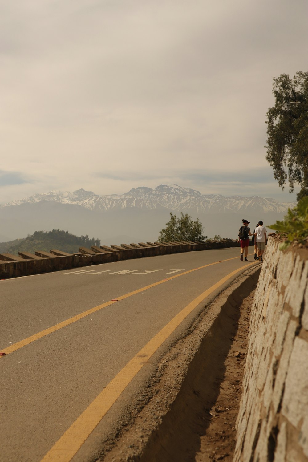 a group of people walking down the side of a road