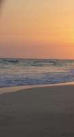 A tranquil beach scene at sunset, evoking relaxation and serenity.