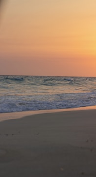 A serene beach scene at sunset in Portugal.